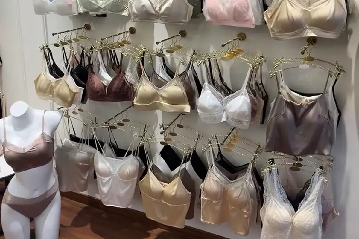 Camisole and lingerie samples in pale colors hanging on showroom rails