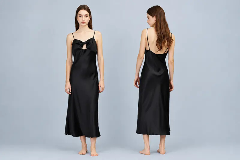 Black long silk slip dress with a front bow and thin straps, shown front and back