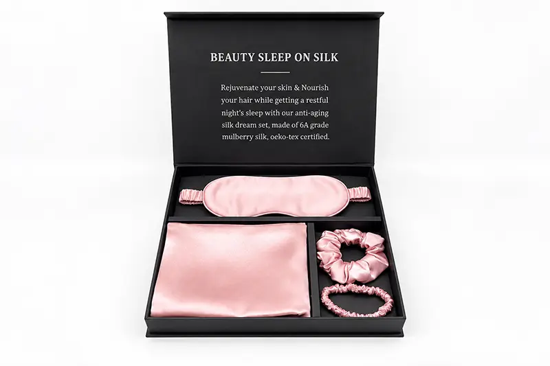 Pink pillowcase, sleep mask and scrunchies arranged in a compartment gift box