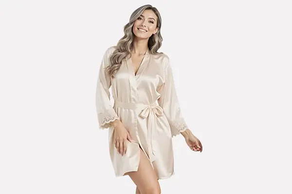 Model wearing an ivory wrap silk robe with lace-trimmed sleeves and a waist tie