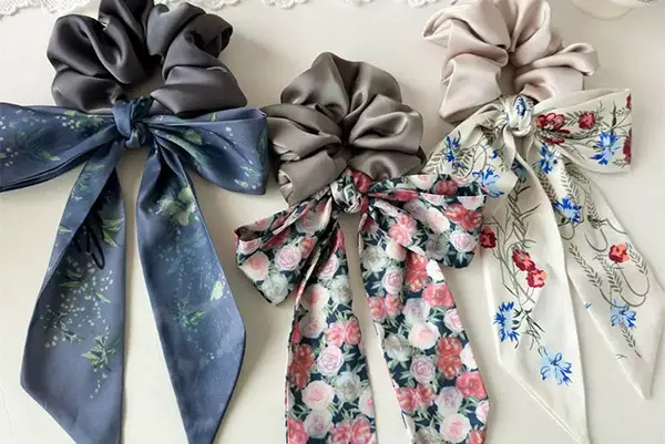 Three silk scrunchies with plain loops and long floral-print bow tails