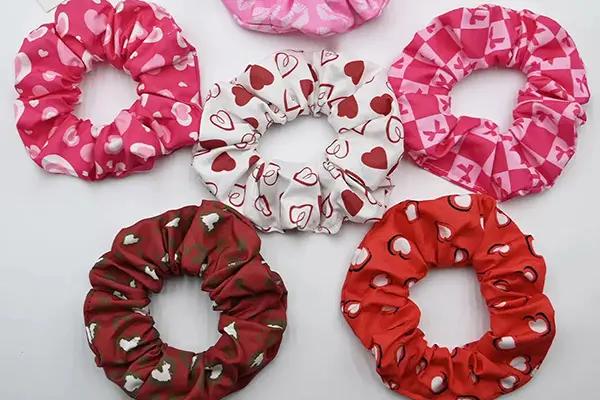 Pink, white and red silk scrunchies with heart and other small printed motifs