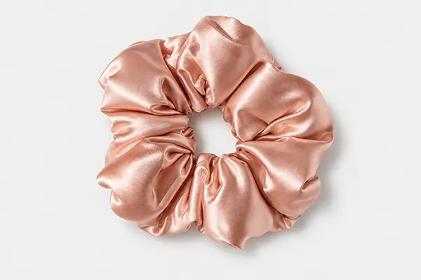 Oversized rose pink silk scrunchie with broad, full fabric folds