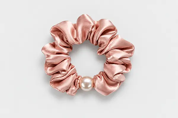 Rose pink gathered silk scrunchie with a single pearl accent