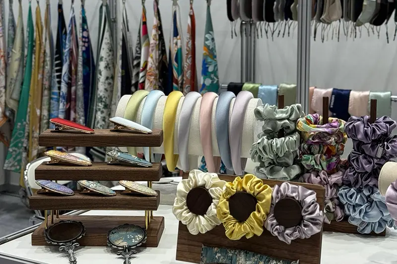 Scrunchies and padded headbands displayed in assorted colors and prints